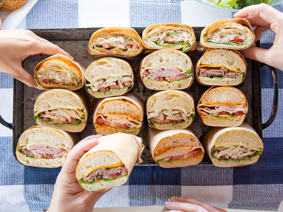 Subs cut in half and lined up for a team lunch